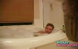 Horny blonde masturbates in the bathtub