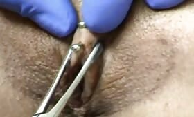 A woman gets pussy piercings